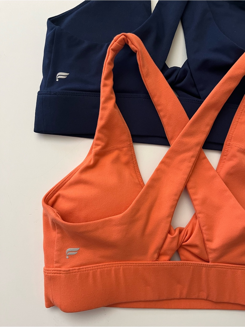 Fabletics | Dual-Pack Cross-Back Sports Bras in Orange & Navy - Picture 3 of 4
